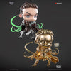 Two figurines, one with green hair and the other gold, on a dark background with 'Secret Lair' branding.